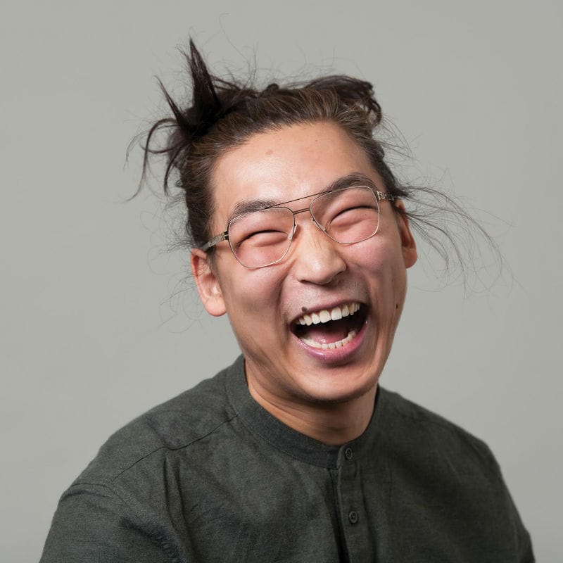 Man laughing wearing glasses.