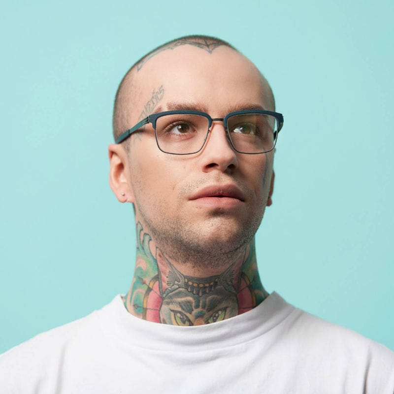 Tattooed man wearing glasses