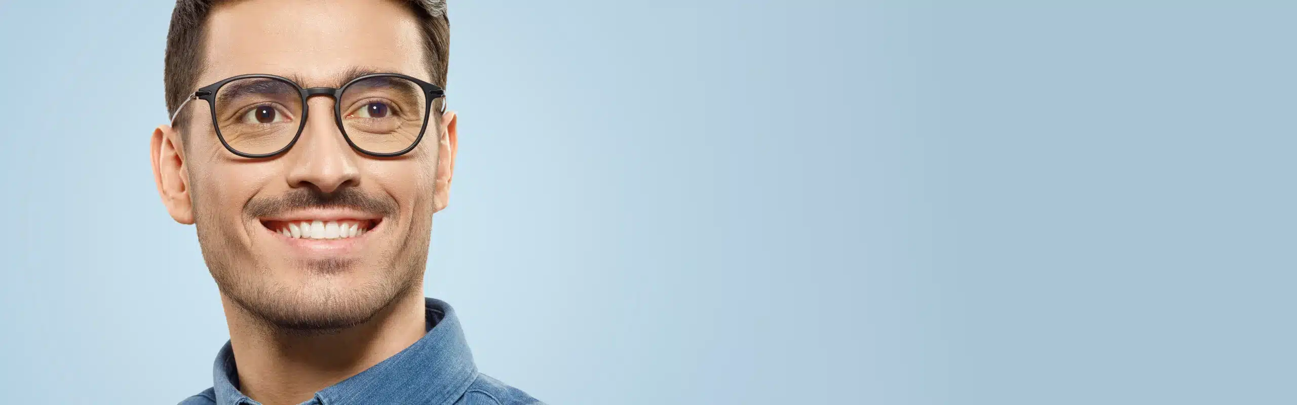 A male with glasses from an optometrist in the Sydney CBD.