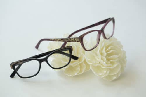 Two pairs os Sospiri glasses resting on flowers.