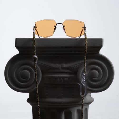 Orange Cazal sunglasses on grecian pedestal.