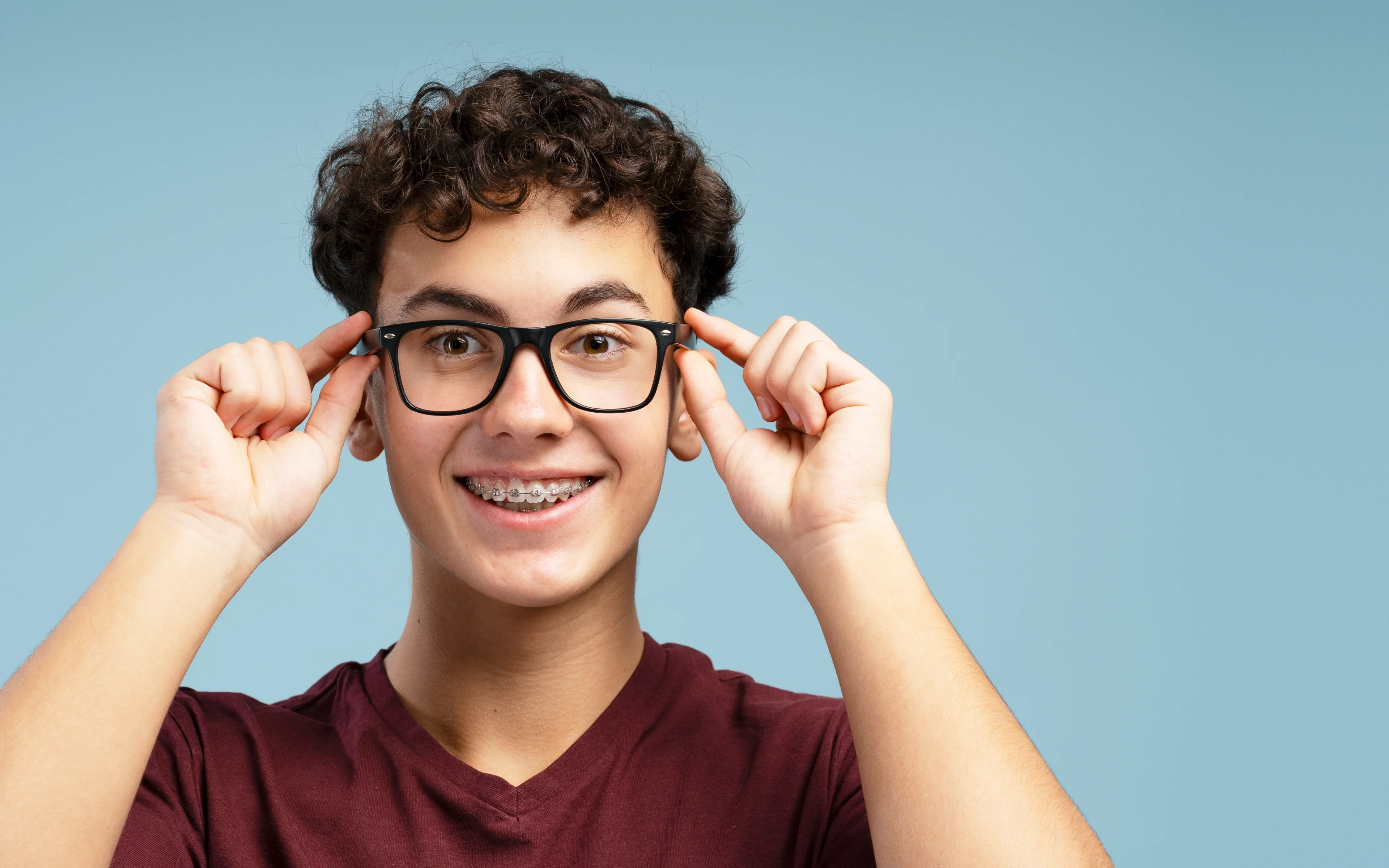 Happy teenager wearing glasses.