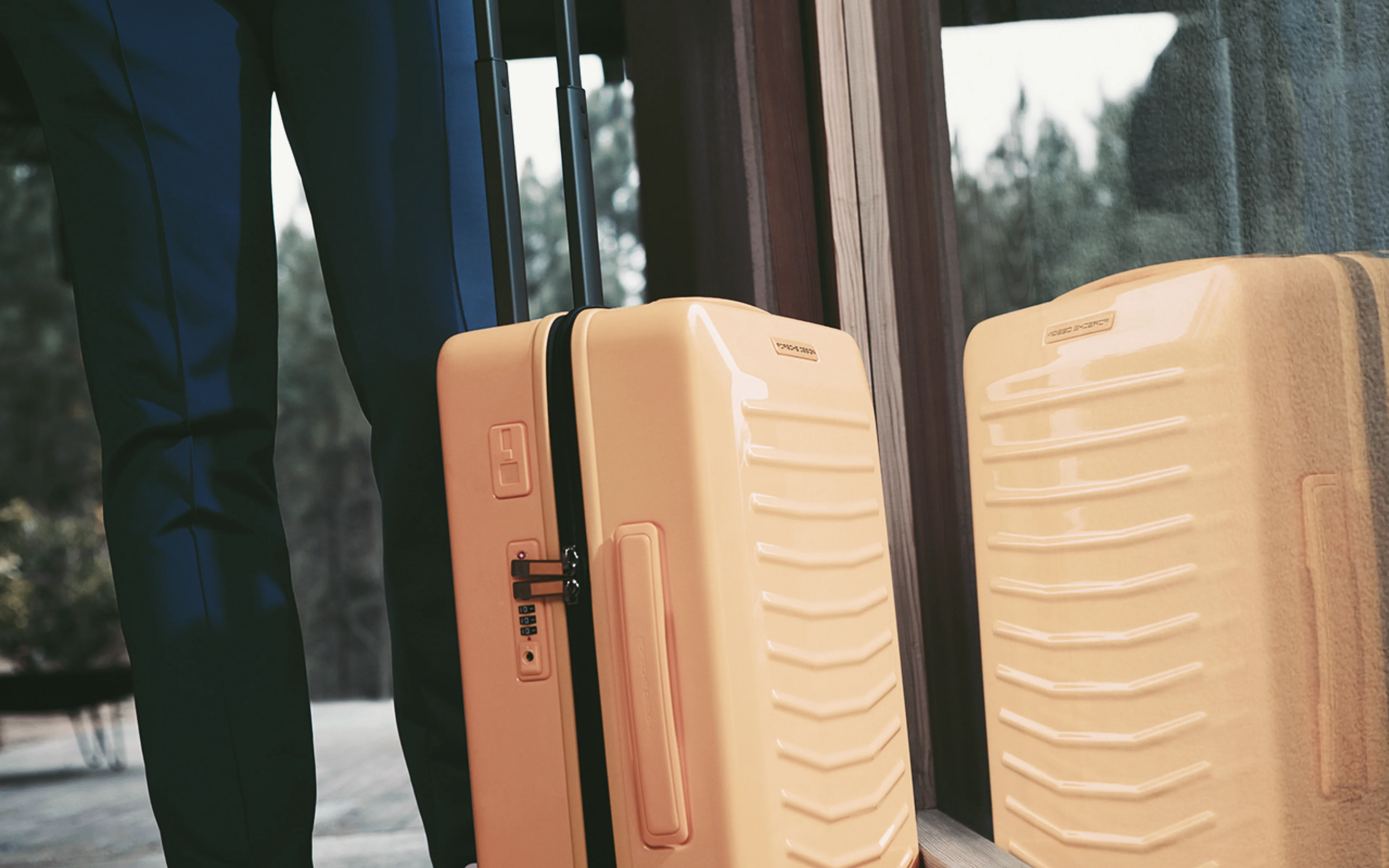 A Porsche branded yellow luggae case.