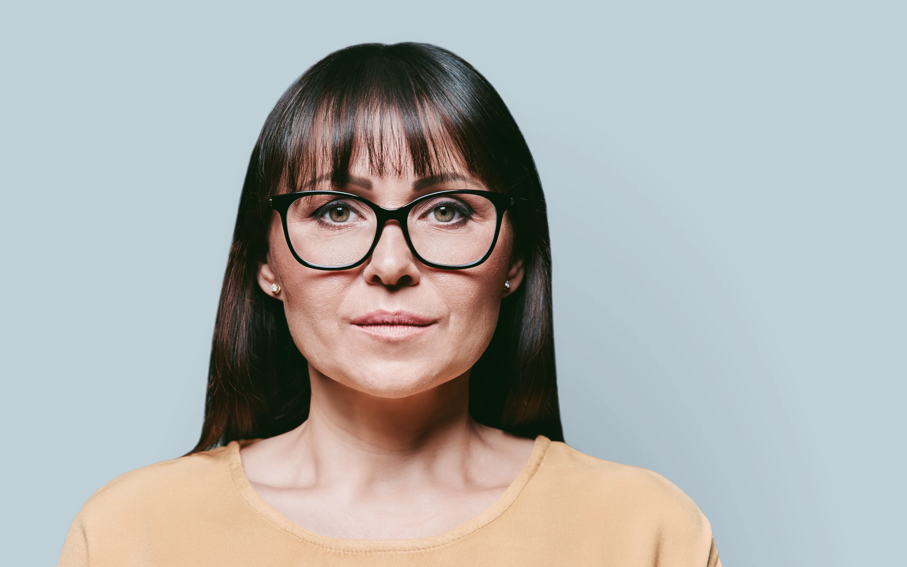 A mature female wearing glasses.