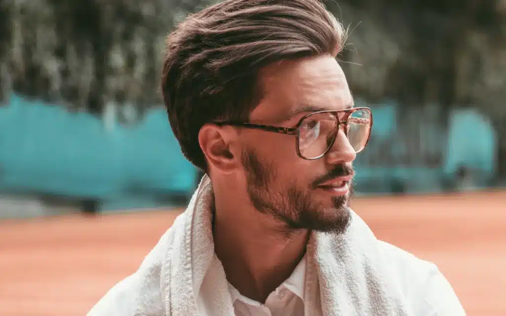 A male tennis player wearing glasses.