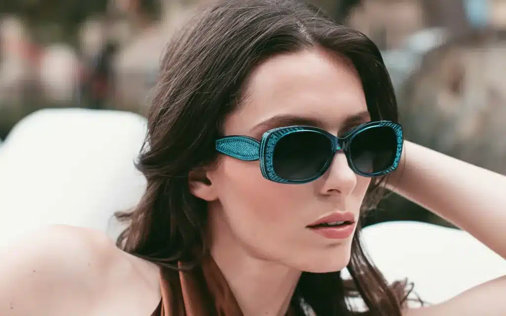 A model wears blue coloured Sospiri sunglasses from the Rina range.