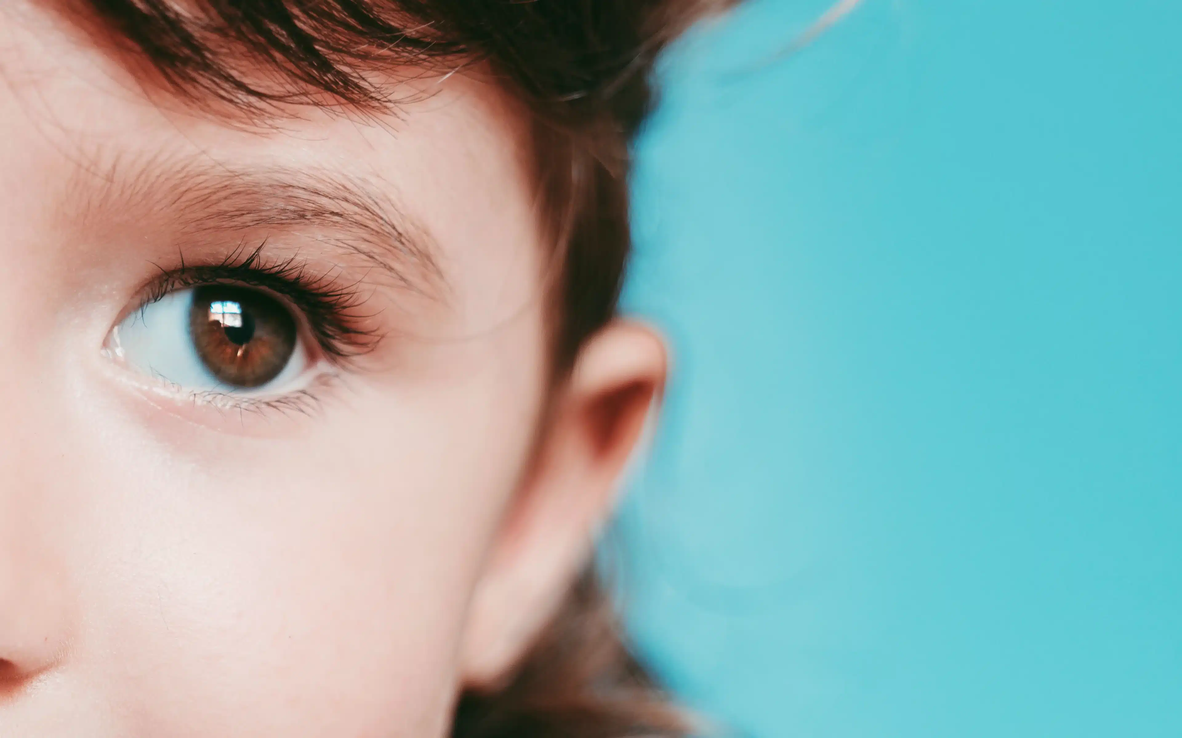 Portrait of cute little girl, blue background