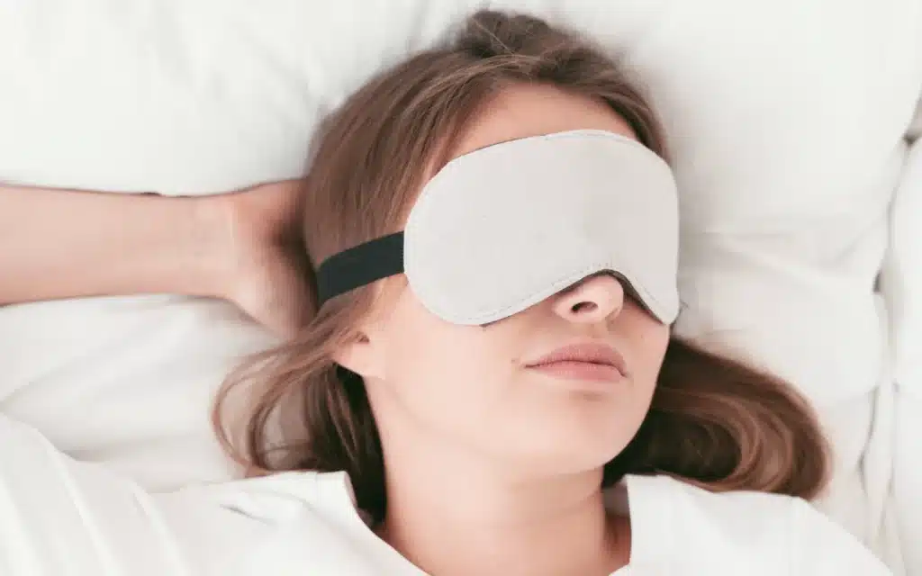 Woman wearing a cold compress eye mask to relieve dry eyes from rosacea